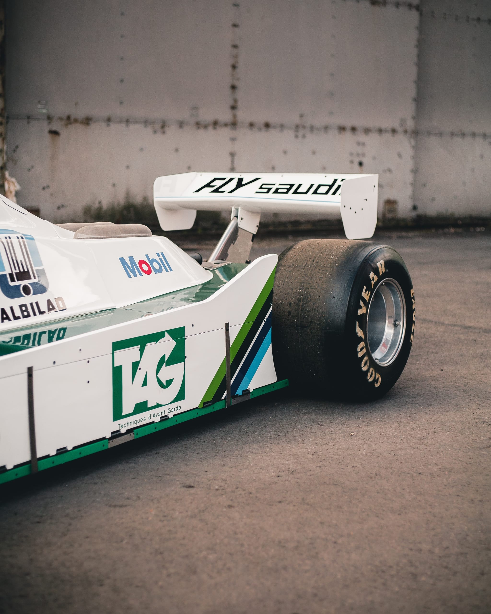 Aerofoils on race cars work on the same aerodynamic principles as aircraft aerofoils, just inverted to generate downforce instead of lift