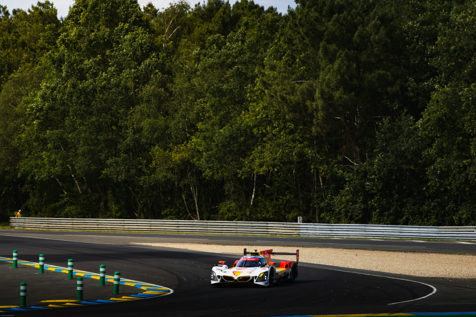 A Le Mans Hypercar rounding a corner at the Circuit de la Sarthe