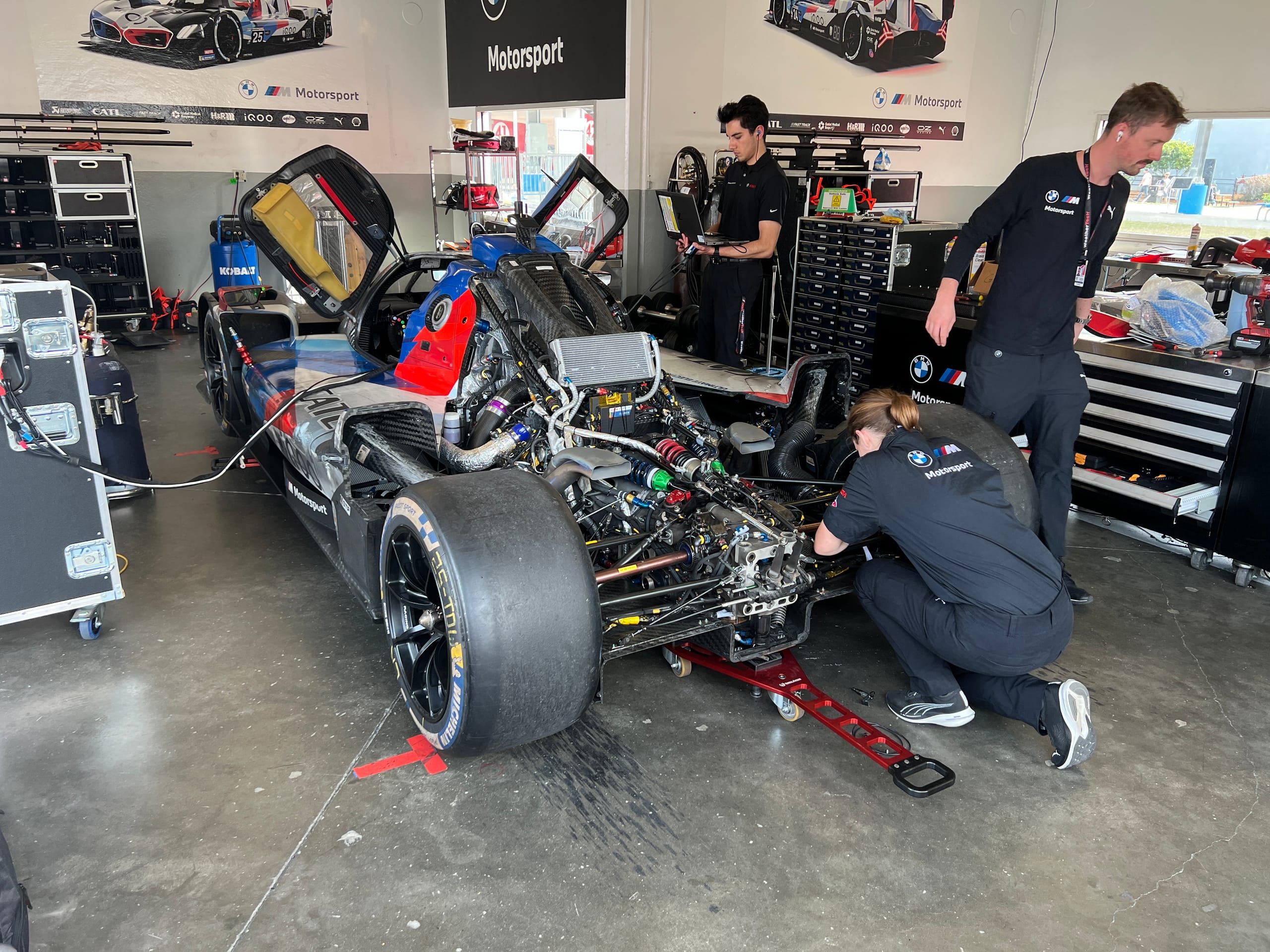 BMW LMDh car with engine cover removed.