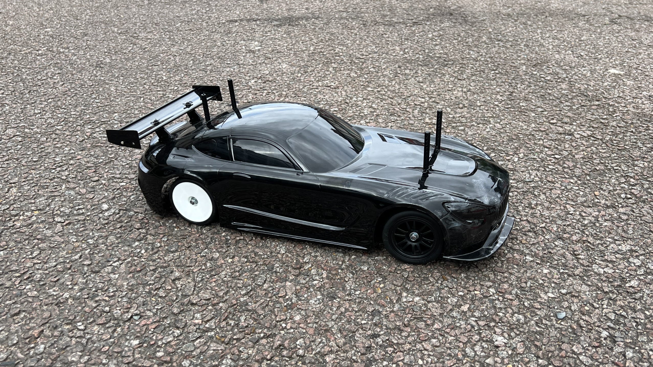 Black RC car on the road