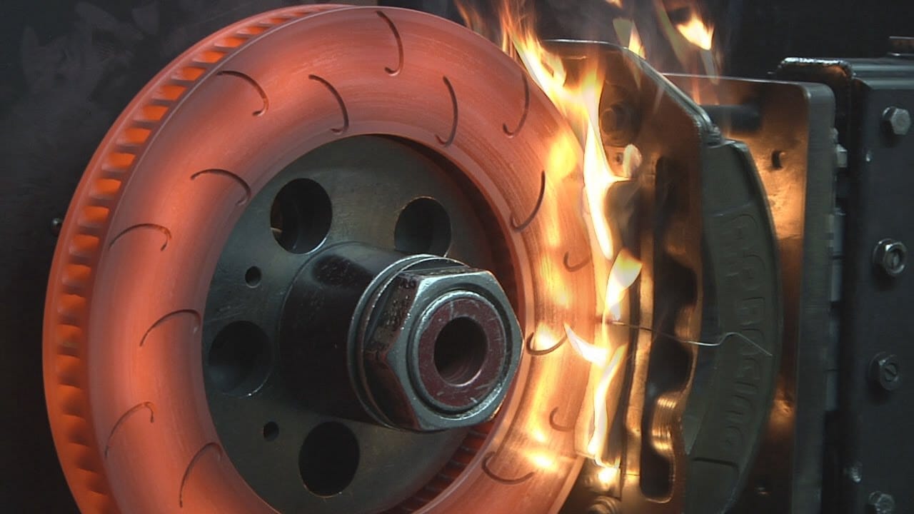 Brake rotor glowing red hot from extreme temperatures generated during repeated heavy braking