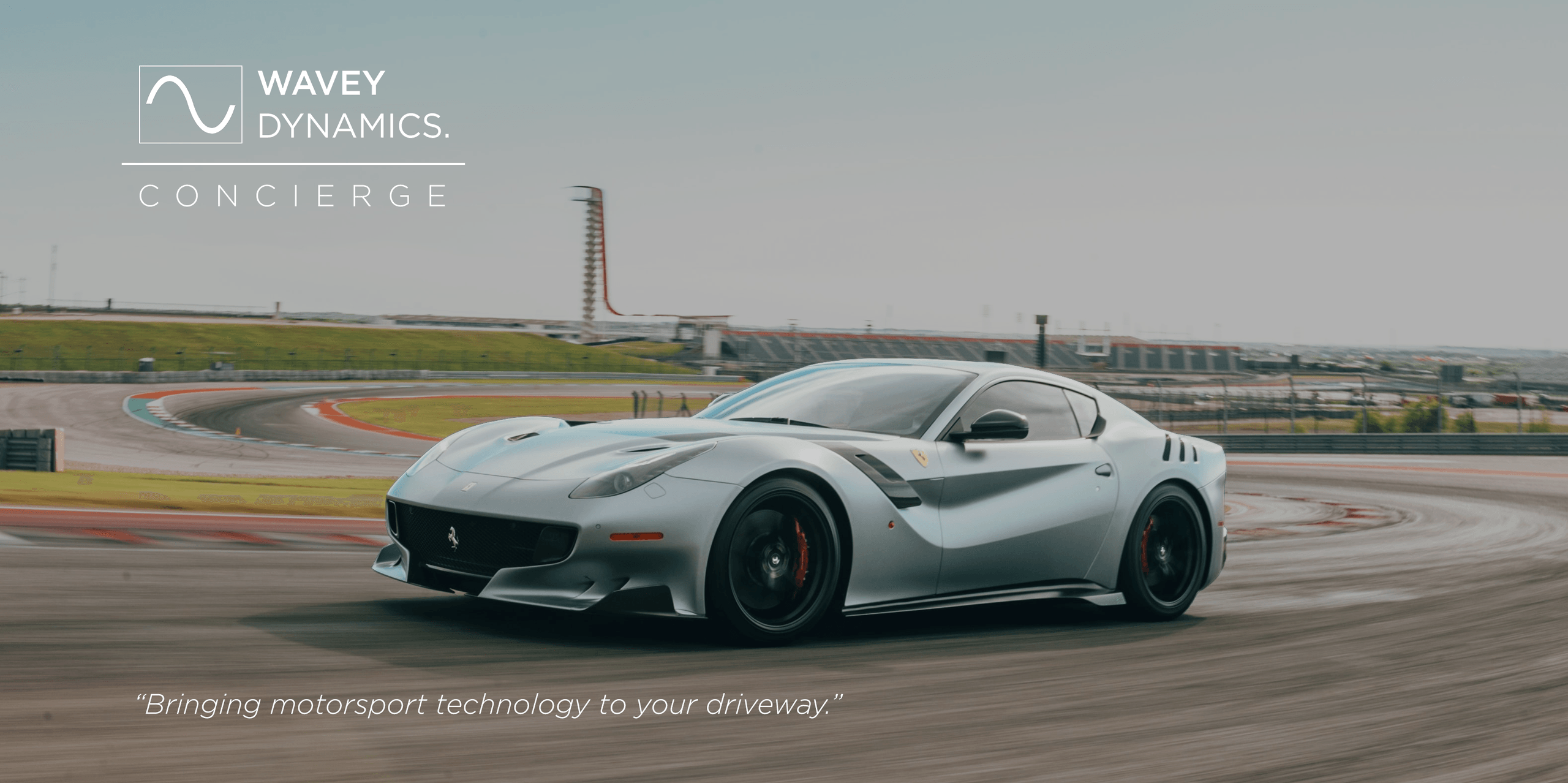 Ferrari F12 on a racing circuit with Wavey Dynamics Concierge branding — Bringing motorsport technology to your driveway